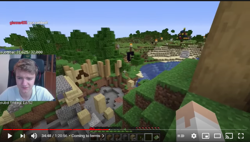 A screenshot from Tommy's stream. Tommy stands on a nearby hill and looks over the crater left behind from the Logstedshire camp. It's a pretty big hole, nothing survived. Farther in the background, we can see a nether portal destroyed as one of the obsidian blocks is gone. Farther along the walkway, we can see various pits and random blocks floating in midair. Tommy's facecam looks like he's about to cry.